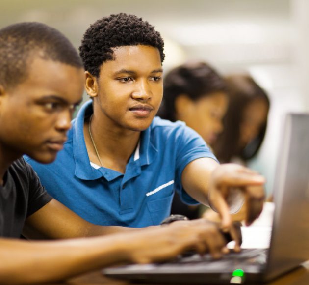 stock-photo-african-college-students-using-laptop-together-126952187